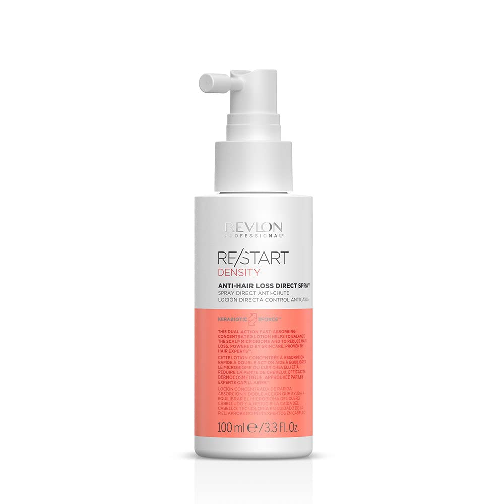 Flacon vaporisateur de soin capillaire Re/Start Density posé sur une pierre claire dans une salle de bain