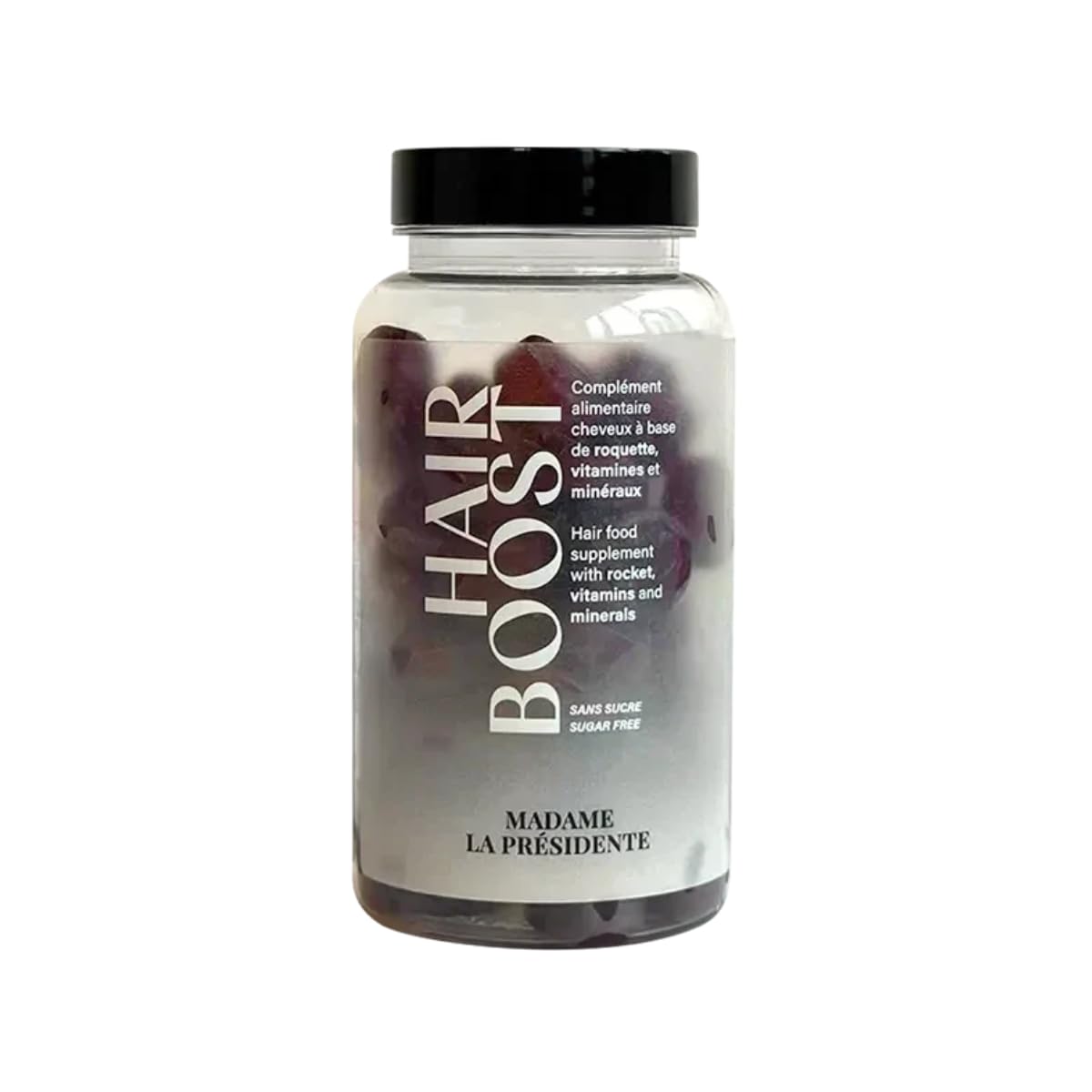 Pilulier de gummies Hairboost à la framboise posé sur une pierre claire dans une salle de bain épurée