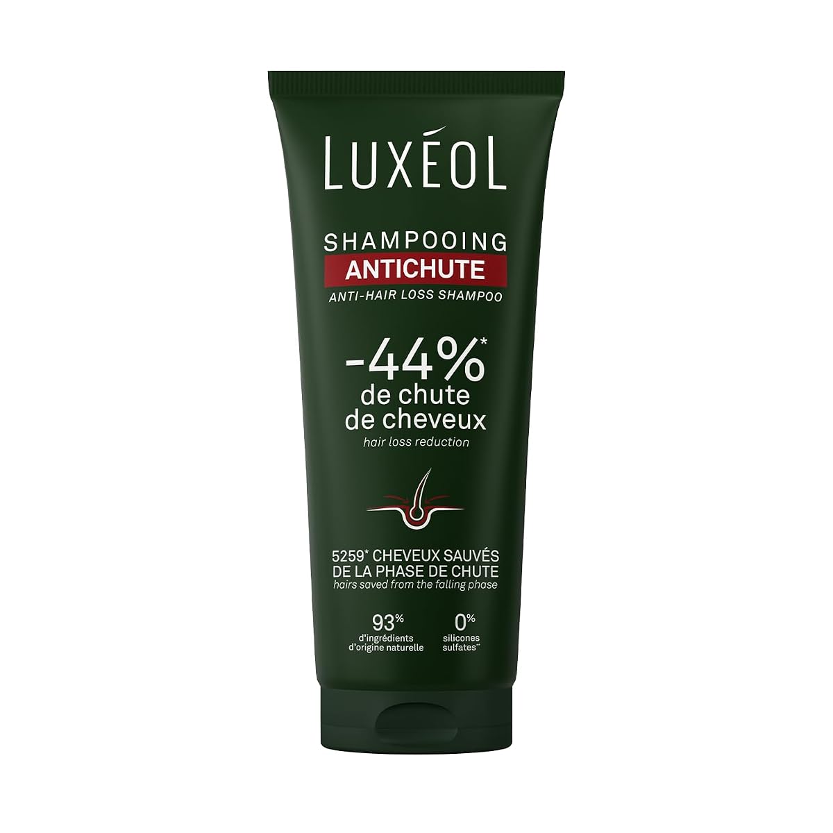 Flacon compact de shampoing Luxéol posé sur une pierre claire dans une salle de bain épurée.