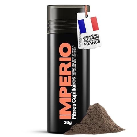 Poudre de fibres capillaires châtain présentée sur une pierre claire dans une salle de bain épurée