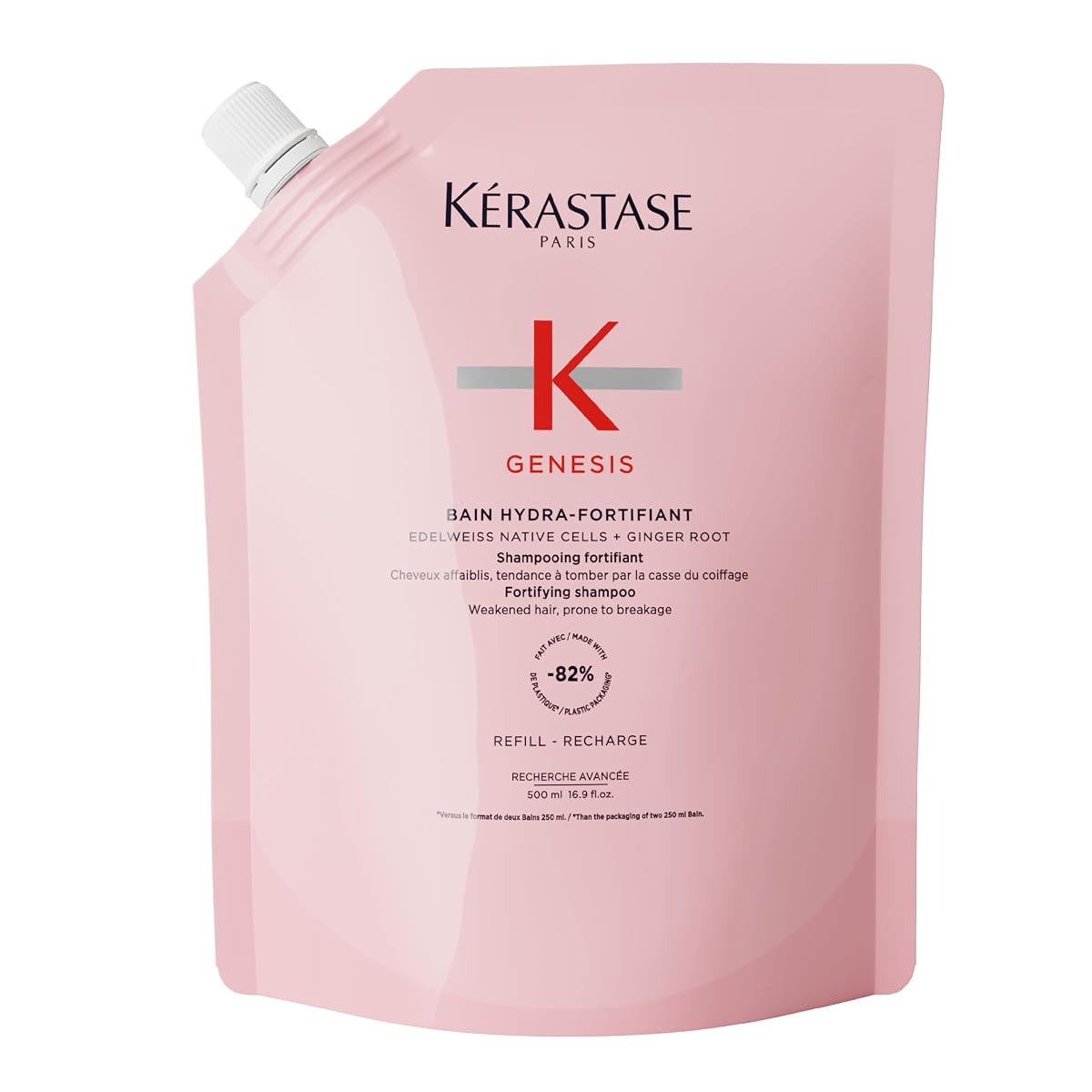 Recharge de shampoing Kérastase Genesis posée sur une pierre claire dans une salle de bain épurée.