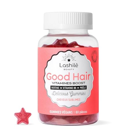 Gummies capillaires en forme d’étoile disposées sur une pierre claire dans un décor de salle de bain épuré.