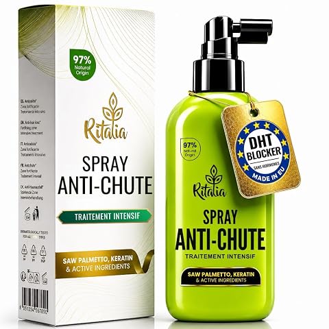 Flacon-spray capillaire beige posé sur une surface en pierre claire dans une salle de bain épurée.