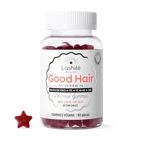 Soixante gummies capillaires en forme d’étoile disposés sur une pierre claire dans une salle de bain épurée.